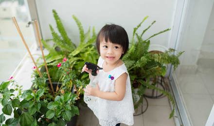 Klein meisje verzorgt kamerplanten